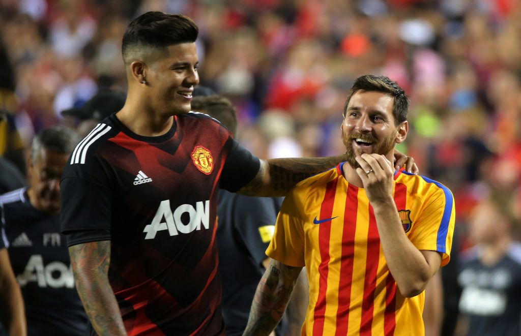 Manchester United's Marcos Rojo and Barcelona's Lionel Messi after the game.