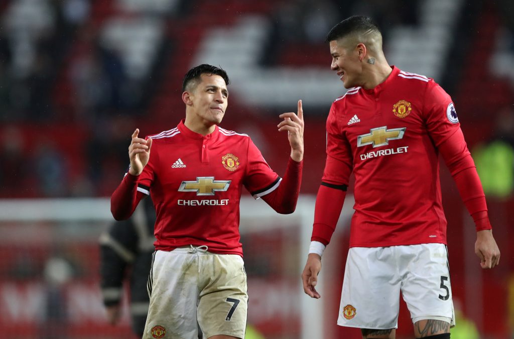 Manchester United's Alexis Sanchez and Marcos Rojo celebrate after the match.