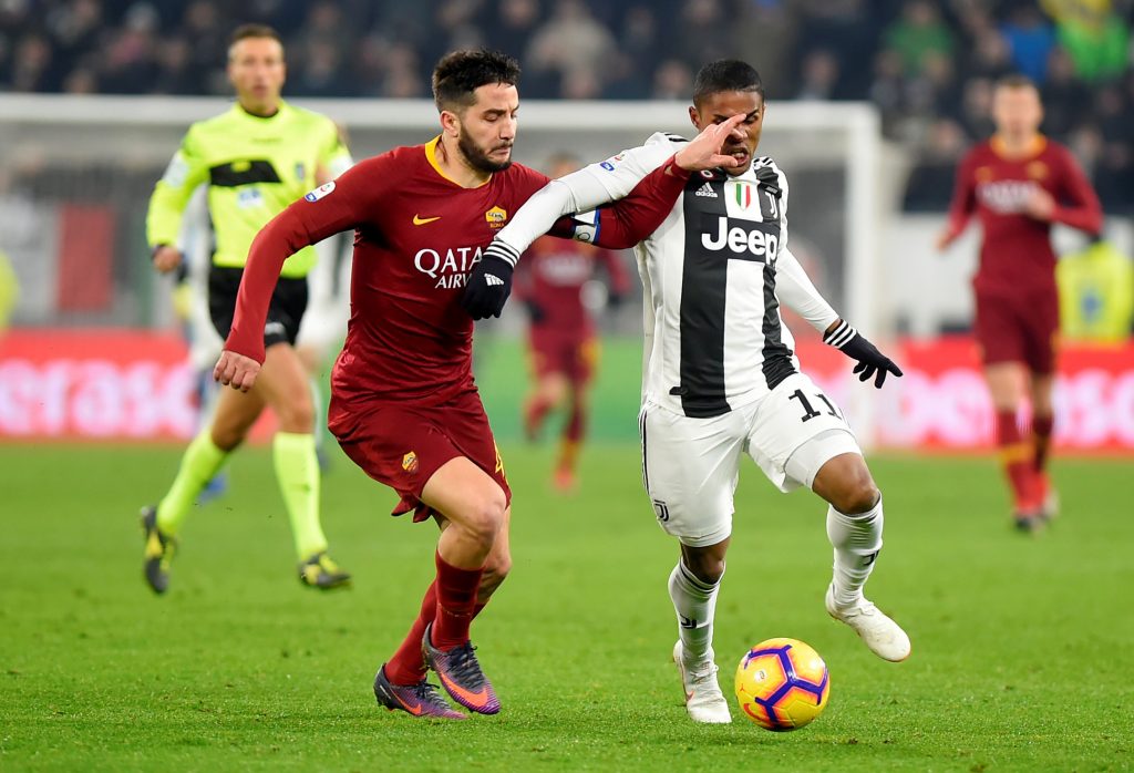 AS Roma's Kostas Manolas in action with Juventus' Douglas Costa.