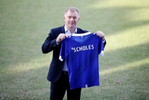 Oldham Athletic manager Paul Scholes poses with a shirt.