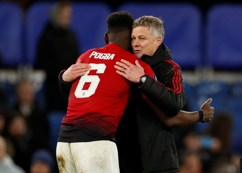 Manchester United manager Ole Gunnar Solskjaer embraces Paul Pogba at the end of the match.