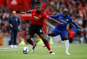 Manchester United's Paul Pogba in action with Chelsea's N'Golo Kante.