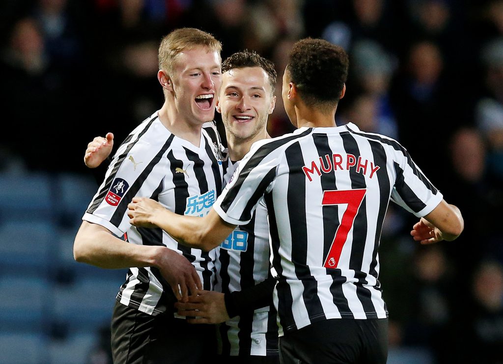 Newcastle's Sean Longstaff celebrates scoring their first goal with Jacob Murphy.