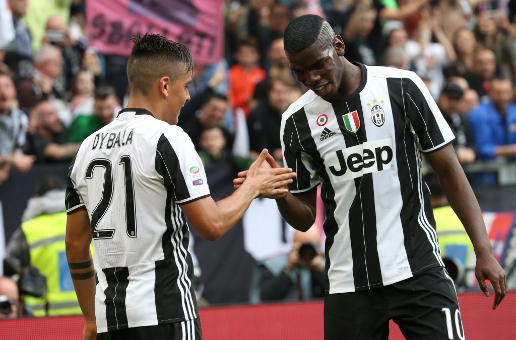 Juventus' Paulo Dybala celebrates with teammate Paul Pogba.
