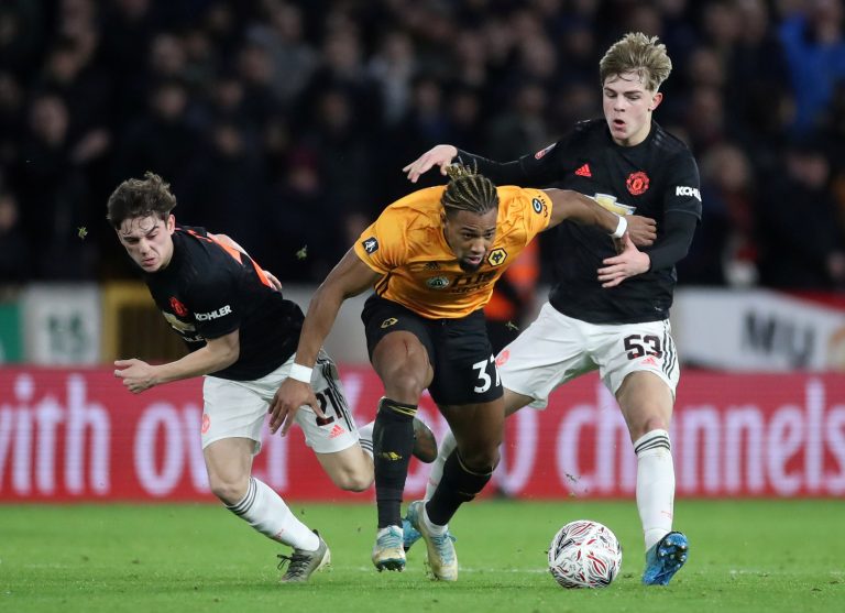 Brandon Williams and Daniel James in action with Wolverhampton Wanderers' Adama Traore.