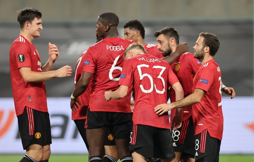 Manchester United's Bruno Fernandes celebrates scoring their first goal with teammates.
