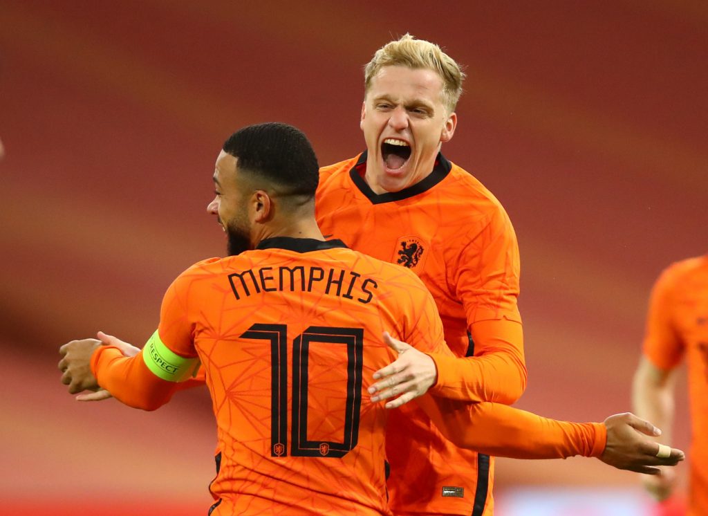 Netherlands’ Donny van de Beek celebrates scoring their first goal with Memphis Depay.