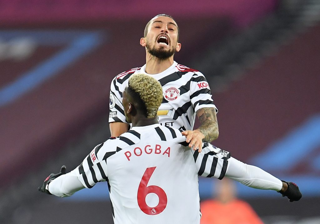 Manchester United's Paul Pogba celebrates scoring their first goal with Alex Telles.