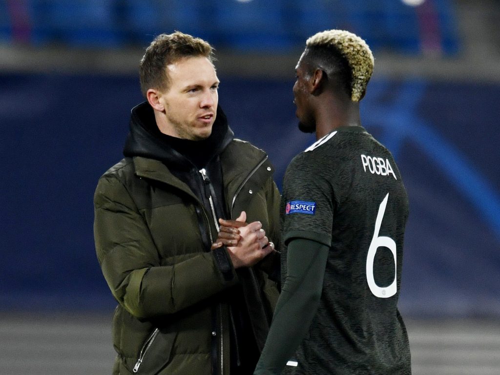 RB Leipzig coach Julian Nagelsmann shakes hands with Man Utd's Paul Pogba after the match.
