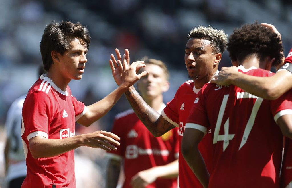 Manchester United's Facundo Pellistri celebrates with Jesse Lingard and teammates after scoring their second goal.