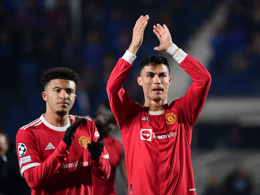 Manchester United's Cristiano Ronaldo and Jadon Sancho applaud fans after the match.