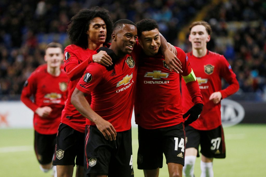 Manchester United's Jesse Lingard celebrates scoring their first goal with Ethan Laird, James Garner, and Tahith Chong.
