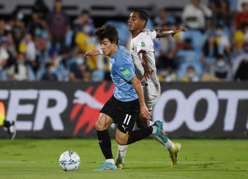 Uruguay's Facundo Pellistri in action with Venezuela's Oscar Gonzalez.
