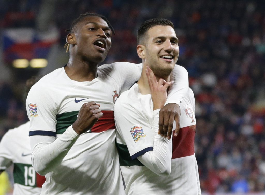 Portugal's Diogo Dalot celebrates scoring their third goal with Rafael Leao.